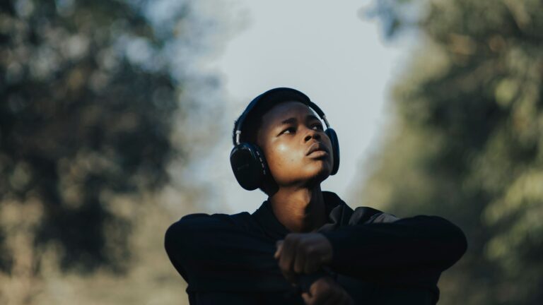 Teenager using headphones while taking quiet time outdoors