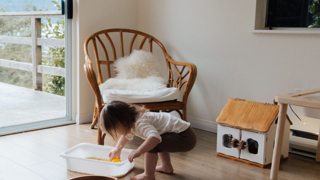 Toddler exploring wooden toys during child-led sensory play