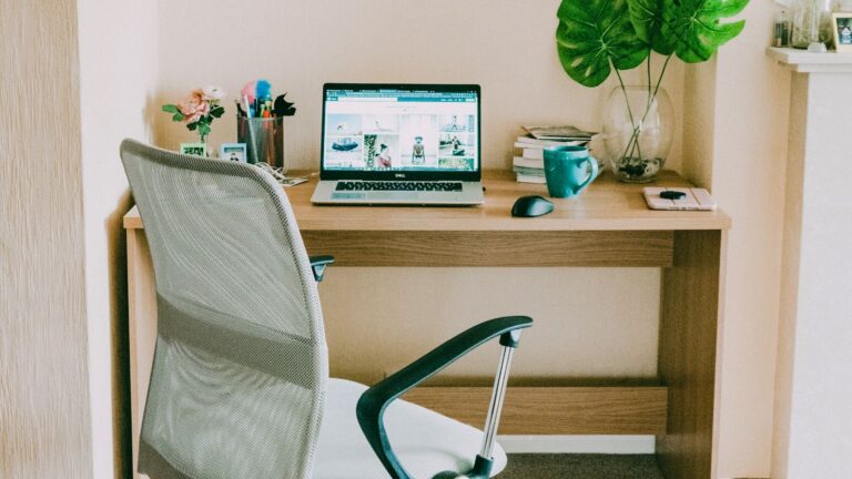 Ergonomic workstation with an adjustable chair, desk and laptop