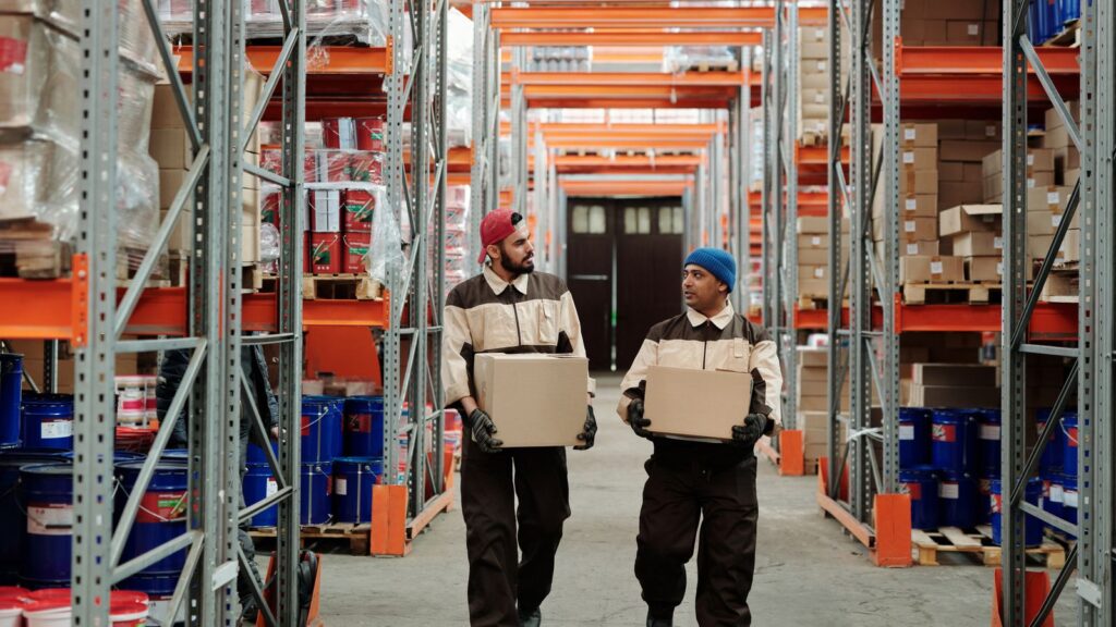 Warehouse employees carrying boxes during their working day